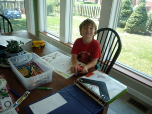 My excited learner, doing his favorite subject: MATH!
